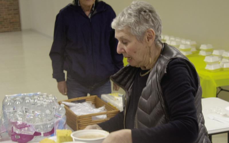 The annual Columbus Lions Club bean feed drew a large crowd. Laura Lowry-Greene carried bowls of beans and cornbread to a table.