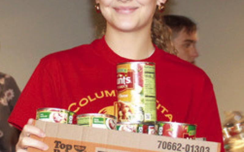 Columbus LEO Club helps assemble Thanksgiving food boxes