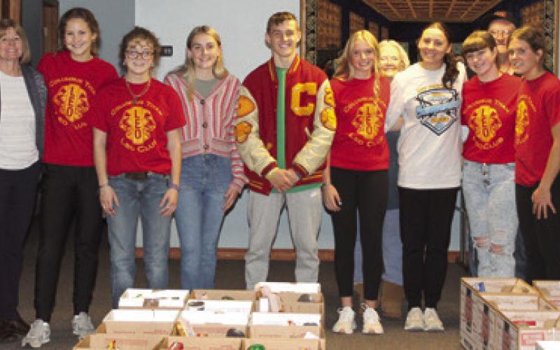Columbus LEO Club helps assemble Thanksgiving food boxes