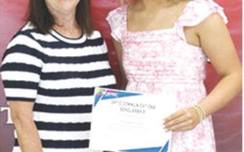 Kenadie Carter received a $1,000 Optic Communications Scholarship from Jane Rhinehart during the 2025 Senior Assembly at the CUHS Gymnasium, May 16.