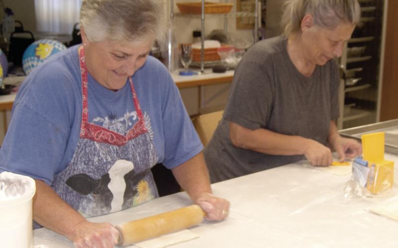 Joanna Hughes was rolling out the dough and her friend was adding slices of cheese to the cut squares of bread dough for the bierocks. The duo were among the many volunteers who were preparing the dish for the annual Oktoberfest dinner at St. Bridgets.
