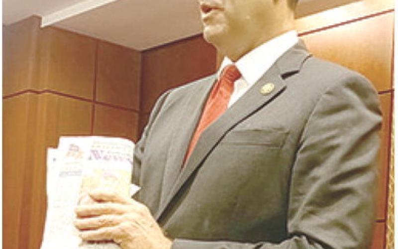 Even politicians in Washington carry something worth reading. Congressman Derek Schmidt had a copy of the recent issue of the News-Report. He said he was particularly interested in the news story about local beef being electrocuted by high power electric lines. Courtesy photo.