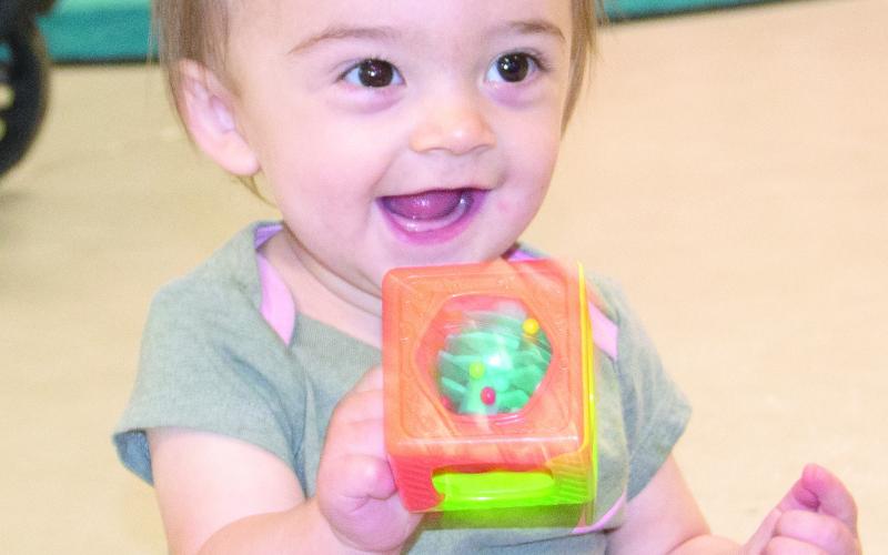 The recent Storytime at the Columbus Public Library was all about rain. Isidora Maple is full of smiles exploring the toys during the event. Storytime events are held each month for children under five. Children can work on an art project while listening to a story on the month’s topic before exploring the many toys available. News Report photo by Tanya Woolsey.