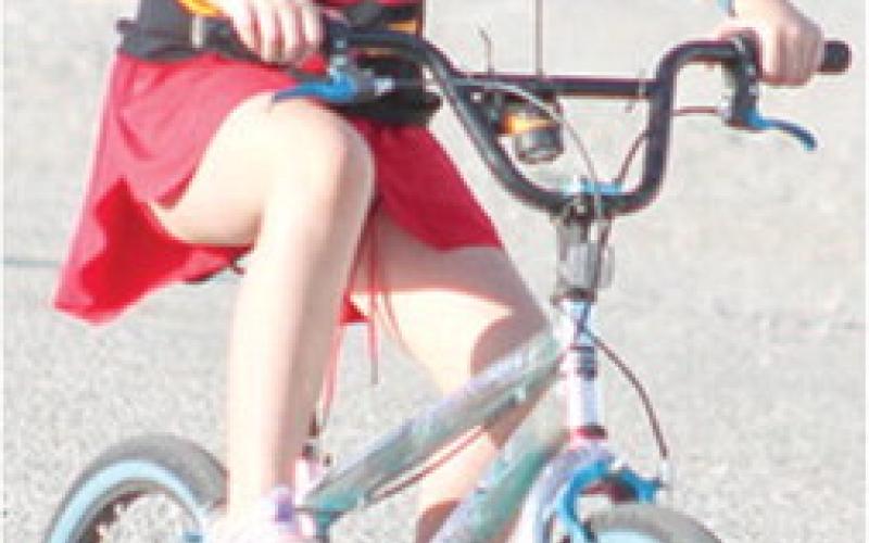 Abi Moeckel raced to a third place finish in the Bike division of the Back-to-School 5K fundraiser for the USD 493 Parent/Teacher Organization, Saturday, at the Fairgrounds.