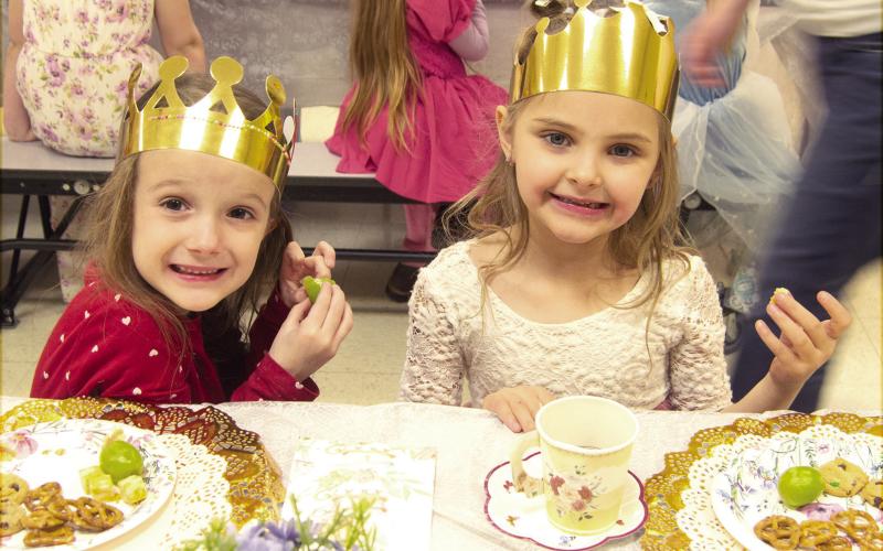 Park Elementary Kindergarteners dressed up and enjoyed a Royal tea party recently. PaisLee Stoner and Sadie Stradley, dressed as princesses, snacked on pretzels, cheese and grapes while having their tea. News Report photo by Tanya Woolsey.