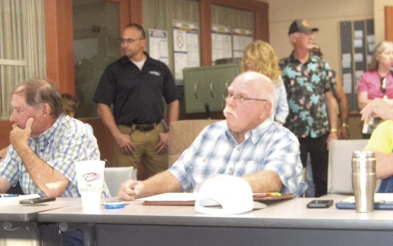 Planning Commissioners Roger Draeger, John Lopp, Randy Commons, and Scott Boyes are surrounded by the community members attending the meeting.