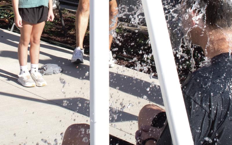 Emersyn Carter watches with glee as water pours onto Park Elementary Principal Matthew Crain. The ‘Dunk Tank,’ sponsored by Coffeyville Community College was part of the annual Back-To-School Carnival hosted at Central Elementary August 27.
