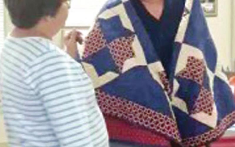 Kathi Lunday with the Pittsburg Quilts of Valor program recently presented Vietnam Veteran Wayne Cook with a quilt in honor of his military service. Photo by Dee Riley.