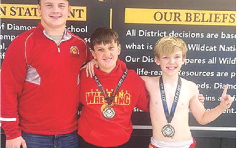Columbus Wrestling Club Members, Trent Smith, coach; Briggs Johnson (second); and Lucus Natalini (first), participated in the Diamond Youth Open Tournament, Saturday in Diamond, Mo. Courtesy photo.