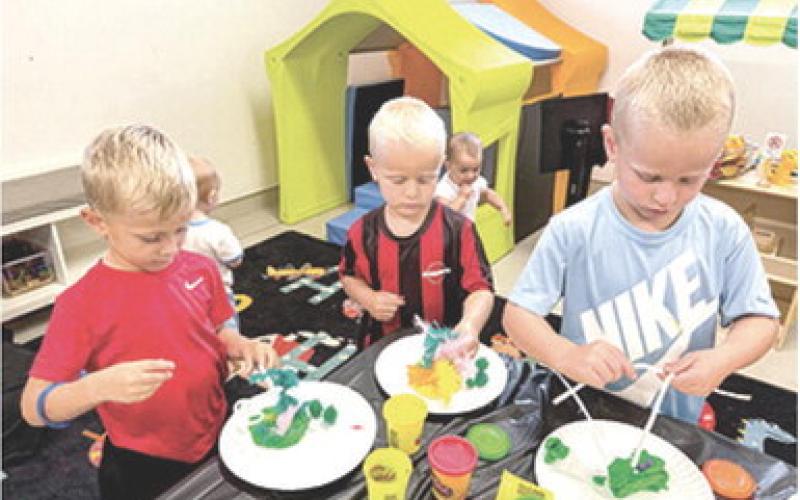 Youngsters under five had the opportunity to imagine and create their own dinosaur habitat at the Columbus Public Library this week. Lincoln Knopp, Beckham Eaton and Barrett Eaton use Play-Doh, pipe cleaners and other craft items to create their dino lands. The Library hosts multiple kid’s events throughout the summer.