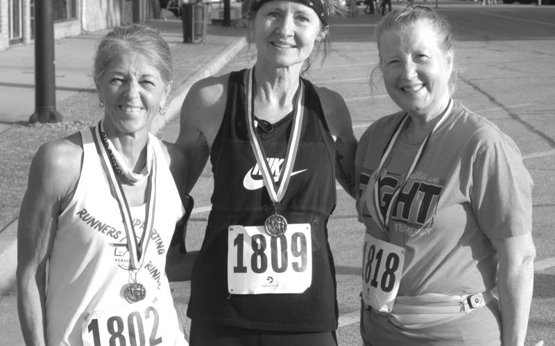 In the female over 60 division of the Columbus Days 5K run Turia Smith, West Mineral, (center) took first place honors with a time of 27.54. Kathy Richart, Carthage, Missouri, was second (at left) with a time of 28:06 and (at right) Phyllis Kelly was third with a time of 35:35.