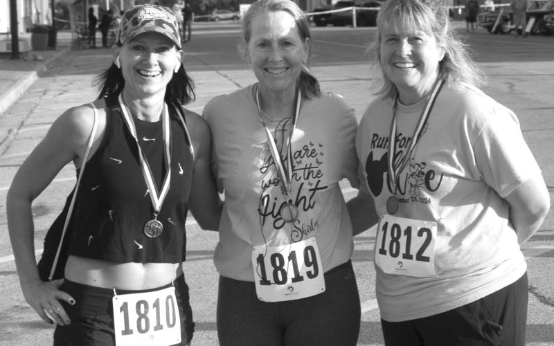 In the female 50-59 age division of the Columbus Days 5K run Missy Proffitt, Columbus, (center) finished in first place with a time of 29:02. Loretta Bass, (left) was second with a time of 28:05 and Lynette Emmerson (right) was third with a time of 39:48.