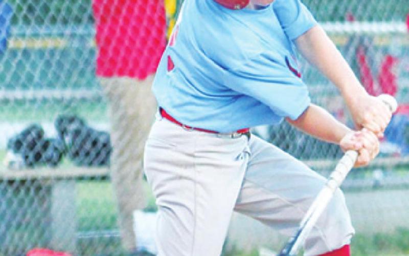 Dayton Hughes connects with the ball during his Mercy Team’s game against Crossland in early June.