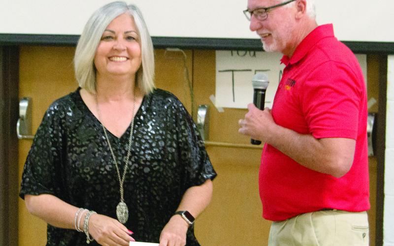 Superintendent Dr. Brian Smith recognized the retiring teacher Shari Napier, during the recognition breakfast on Friday. He noted that he and Shari had been in school together before she taught for 36 years in the local district.