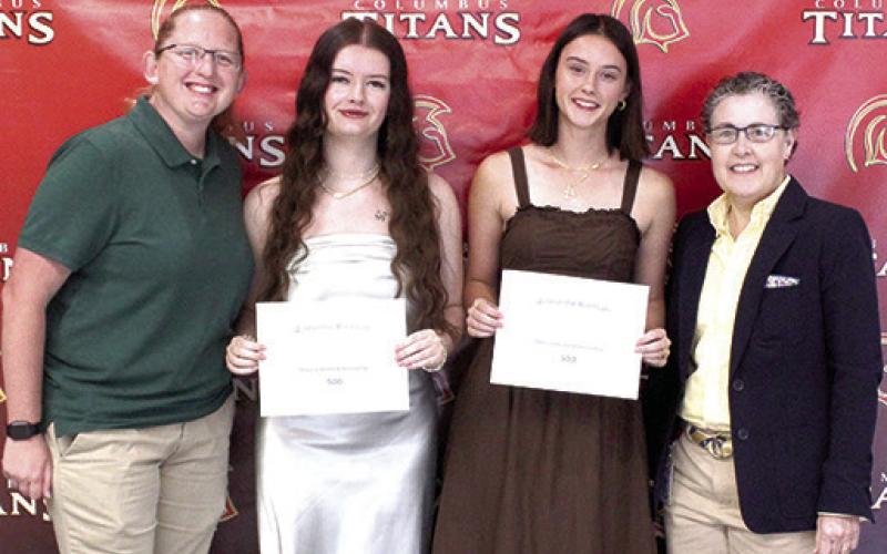 Jacianna Heflin and Piper Hayes received the Marcia Smith Memorial Scholarship in the amount of $500 each from CUHS Instrumental Music Assistant Director, Christine Lovell and Instrumental Director Gae Phillips during the Senior Assembly, May 15, at the Columbus Unified High School Gymnasium.