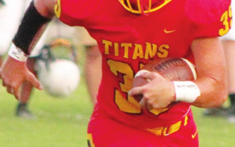Titan Senior, Trent Smith, picks up yardage against Coffeyville in the 40-8, Columbus win, Friday at Titan Stadium. The Titans are in action tonight at Girard.