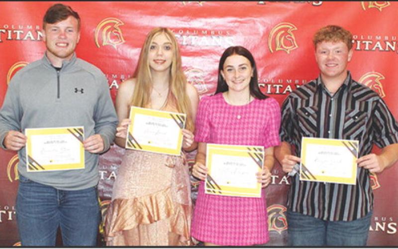 Four Columbus Seniors were awarded the Columbus Community Foundation Maureen Paulsen Scholarship during the Senior Assembly, May 16 in the Columbus Unified High School Gymnasium. Brandon Stice, Anna Head, Mallory Thompson, and Kanyen Smith each received a $1,000 scholarship, presented by Kelly Walters, USD 493 Title 1 Reading Specialist.