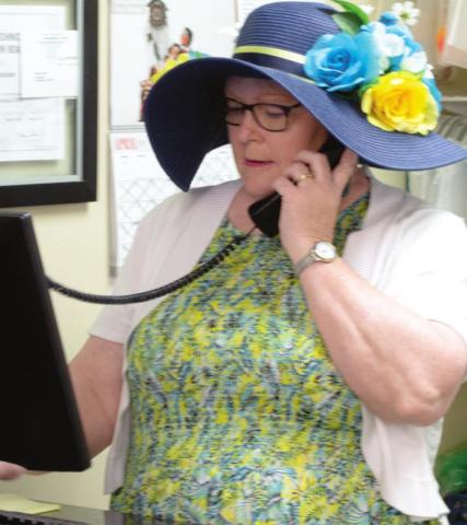 Linda Evans talks with a customer