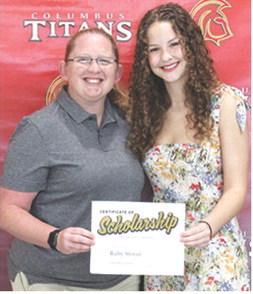 Ruby Stover earned a music scholarship and Presidential Scholarship from Emporia State University in the amount of $26,250 from CUHS Assistant Instrumental Music Director, Christine Lovell, during the May 16 Senior Assembly at the Columbus Unified High School Gymnasium.