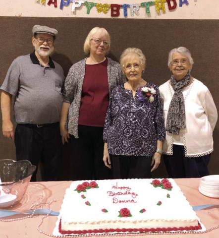A come and go celebration was held Saturday in honor of the 90th birthday of Donna Lyerla (second from right). Bill Holden, Cathy Holden and Melissa Mc-Cool helped with decorations and adorning the table. Lyerla is a former Columbus resident and was a music teacher for a number of years. Courtesy photo.