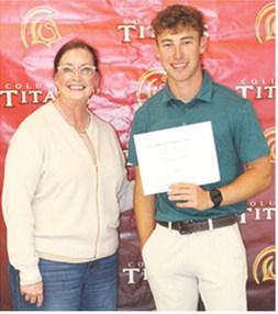CUHS Senior, Lemmie Stone, received the Columbus Alumni Scholarship for $600 from Rebecca Spooner during the May 15 Senior Assembly at the Columbus Unified High School Gymnasium.