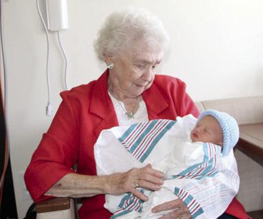 Columbus resident Ruby Wright, 90, has knitted over 1,000 caps for NICU babies at Freeman Hospital West in Joplin, Mo. She had the opportunity to hold Truett Percival, one of the recipients of her caps. Courtesy photo.
