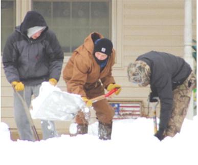 Three Titan Wrestlers Korbyn Newberry, Chase Pelt and Shade Schuberger, helped clear a path for the senior tenants to get to their mail and to the laundry area at Central Apartments Wednesday.
