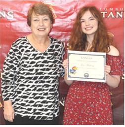 Senior Ava Hulvey received a $20,000 University of Kansas Chancellor Scholarship from CUHS Instructor, Karen Langerot, during the 2026 Senior Assembly at the Columbus Unified High School Gymnasium, May 15.