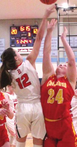 Lady Titan Senior, Bailey Monroe is fouled by Lady Lion Senior, Kennedy Krokroskia, in the 44-33 Columbus loss at the SE Lancer Classic opener, Monday. Bailey made 10 of 14 free throws in the game.