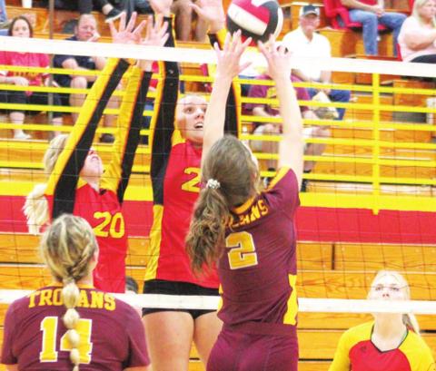 Lady Titan Sophomores, Gracie Major and Katie Simpson get a block at the net against Girard Senior, Kinley Smith, during home matches recently. Senior, Lexy Stone, is ready and awaiting the outcome of the play.