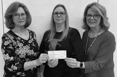 Parsons PEO member Janie Barcus and PEO president Debra Shaw present annual scholarship to Karie Leslie.