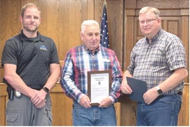 Jim Oberbeck (center) was recognized for his years of service to the City of Columbus, as well as County law enforcement. Oberbeck is retiring from his official duties. Columbus Police Chief Kyle Clark and Mayor Grant Spieth presented Oberbeck with a plaque at a recent City Council meeting.