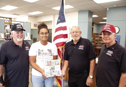 Members of the Little Balkans Chapter of the Sons of the American Revolution presented the Columbus Public Library with a new flag and a book about America. John Gilpin, Lauren Dainty, Rick Parmele and Martin Dupslaff were on hand for the presentation.