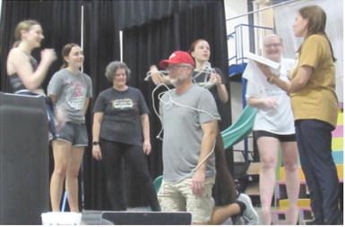 Cast members of 9 to 5: The Musical, rehearse a scene. Actors include ladies left to right: Khloee Cox, Mallory Thompson, Michelle Atchley, Madalyn Weeks, Kaylee Denton and choreographer Melissa Thompson-Holt. Center Chad Fletcher in the role of Franklin Hart. Courtesy photo.