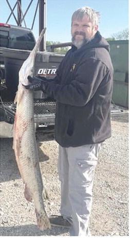 Michael Barnett of Baxter Springs landed a 33.6-pound, 63-inch-long longnose gar on April 18, 2026, while fishing the Spring River near Baxter Springs, ending a state record that stood for more than 50 years. Photo courtesy Kansas Department of Wildlife and Parks.
