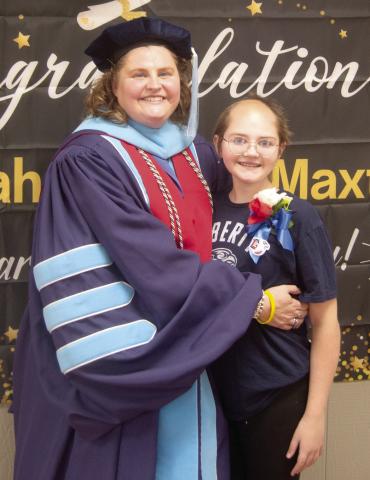 A reception for Dr. Sarah Garner Maxton was held recently (May 25) at the Baxter Springs Community Center. This has been quite a journey for the “high distinction” Liberty University graduate. All this while her daughter, Eva, was battling Ewing Sarcoma Cancer. Sarah was wearing her graduation robes with scholar accoutrements and her 4.0 Grade Point Average medal.