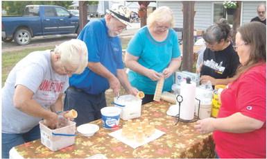 Dipping ice cream cones Friday night at the Weir Homecoming were Kay Lynn Jites, Bill Holden, Cathy Colden and Sue Ann Barnes.