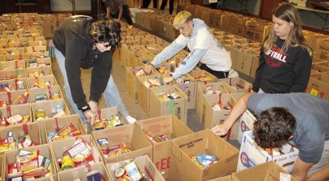 Columbus High School students helped pack over 7,000 items into the food boxes that will be distributed for Thanksgiving. Volunteers make the project a suc-