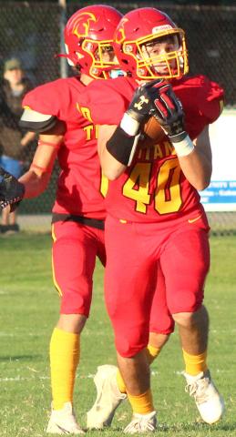 Trojans sneak past Titans in opener