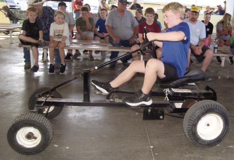 Brooks Barcus tried his skill in the Kids Tractor Pull Tuesday night of the Fair.