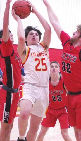 Titan Freshman, Jack Vilela, goes up for two of his team-high, 11 points in the junior varsity loss to Baxter Springs. Tuesday at the Central New Gym. Freshman, Jacob Grant, sophomore, Payton Gaines, and junior, Logan Gess defend for the Lions.