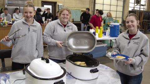 Serving pancakes and sausage Trinity Green