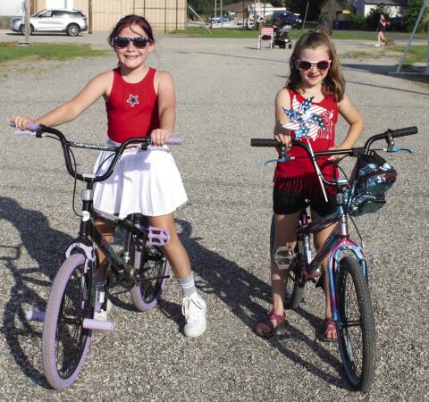 Maci Livingston and Abigail Moeckel finished first in the girls bicycle division of the Fourth of July 5K.