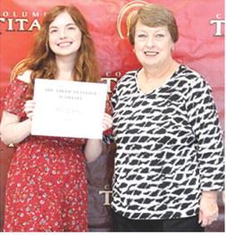 Senior Ava Hulvey, received the American Legion, Sunflower Girls State Scholarship for $250 from USD 493 Instructor, Karen Langerot, during the May 15, Senior Assembly at the Columbus High School Gym.