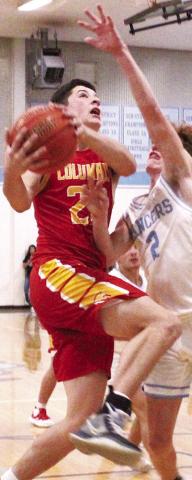 Titan Senior, Cole Minor, goes to the hoop against Lancer Senior Drake Guymon in the 57-41 Titan win at Southeast, Friday.