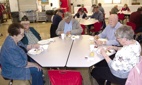 Enjoying breakfast at the CJSHS Veterans Day Assembly were local Veterans Dewey Smith and wife LaDonna, Kenneth Frobish, Pastor Jim Lewis and Marilyn Frobish.
