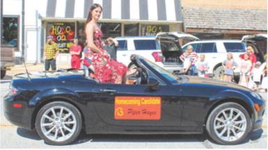 Columbus Unified High School 2025 Homecoming Queen Piper Hayes waved to the crowds during the parade up Maple Street Friday after noon. The crowning took place at half-time of the Neodesha-Columbus football game.