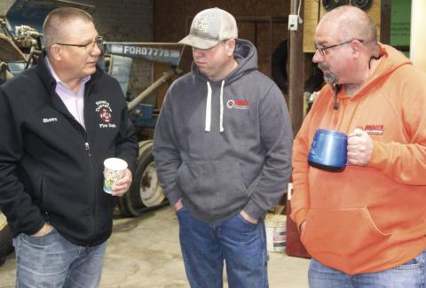 Chamber of Commerce member Shawn Carter visits with Mike Bartling and Mike Boesker of Hammer Tires and Service at the Chamber of Commerce Third Thursday coffee. This is the first coffee after the COVID pandemic had caused the monthly event to be discontinued.