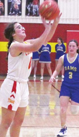 Lady Titan Freshman, Katy Mooney, shoots one of her four, three-point shots as Lady Ram Junior, Chloe Parker looks on. Katy led all scorers with 16 points in the Columbus 31-43, loss to Riverton, Tuesday. Parker scored 13 points to lead the Lady Rams in scoring.