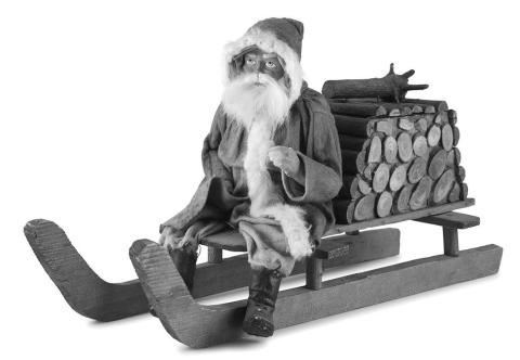 Leave it to Santa Claus to fill a bundle of firewood with candy! This papiermache figure of Santa on a sled is a candy container.